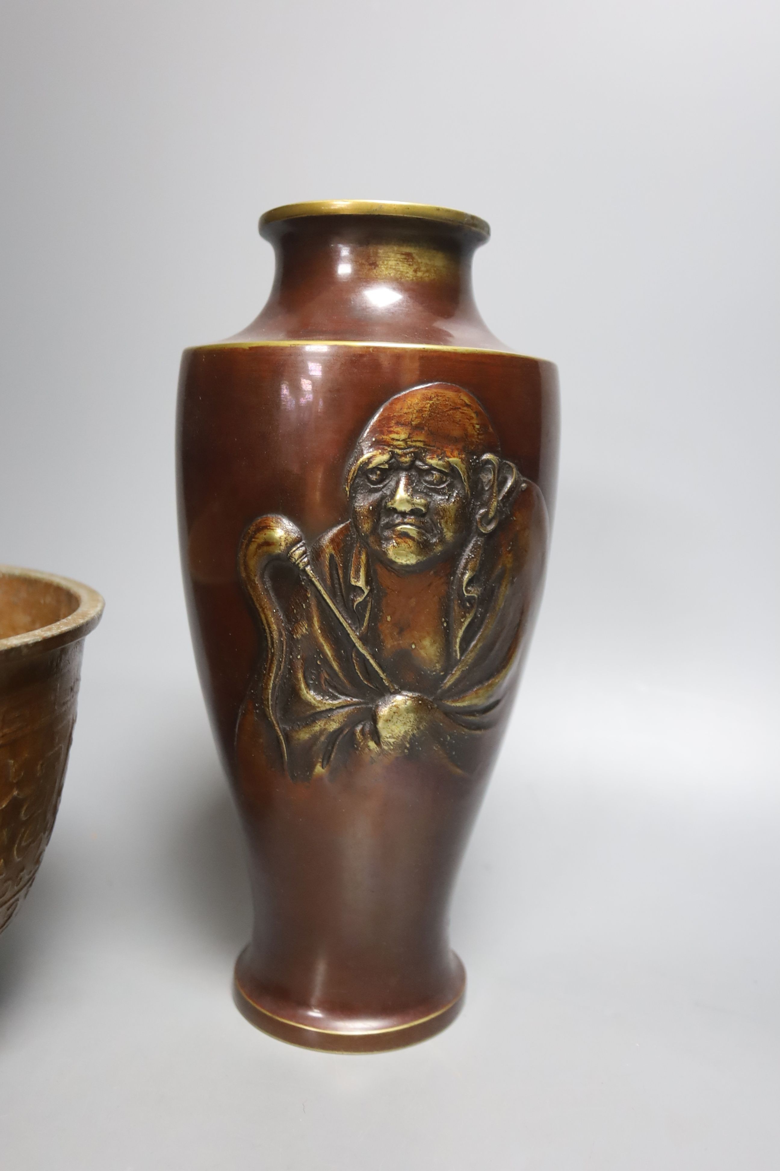 A Japanese bronze 'Daruma' vase and a pair of bronzed aluminium tripod bowls, vase 25 cms high.